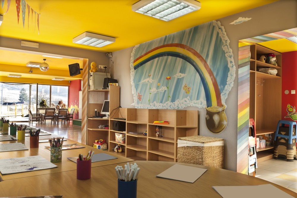 preschool classroom with a rainbow over a bookcase