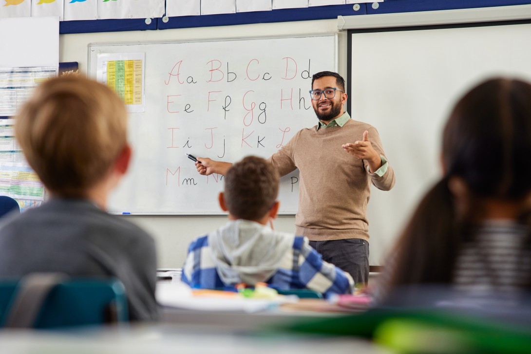Educator teaching students the alphabet.