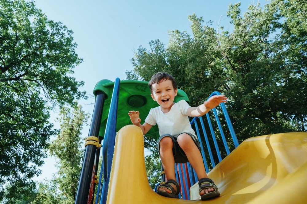Young student using a slide. 